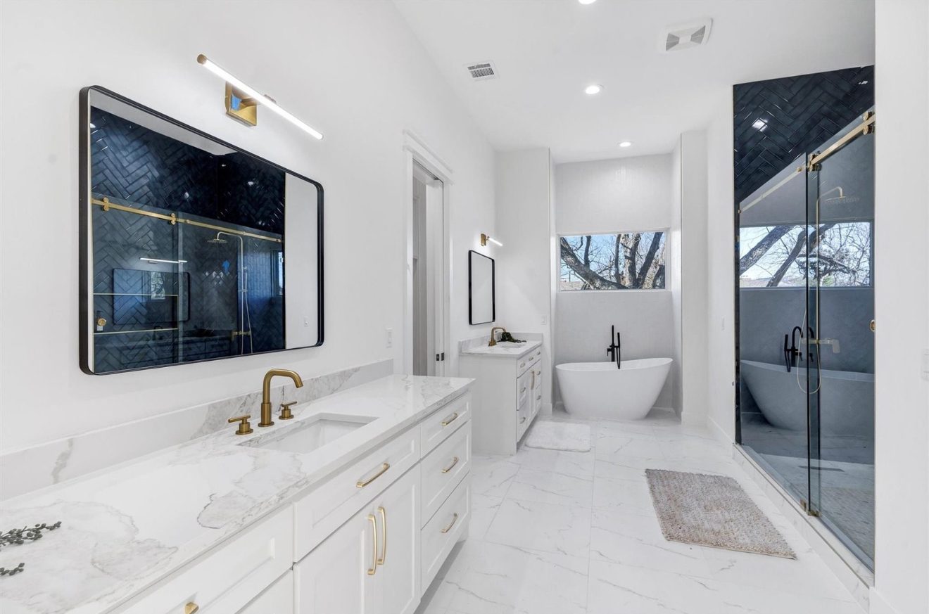 Bath with black herringbone tile shower