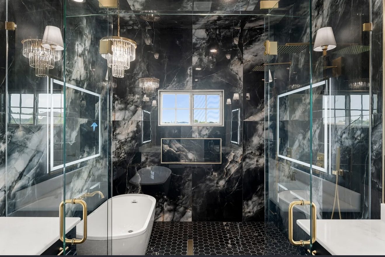 Black marble primary bath with glass wet room