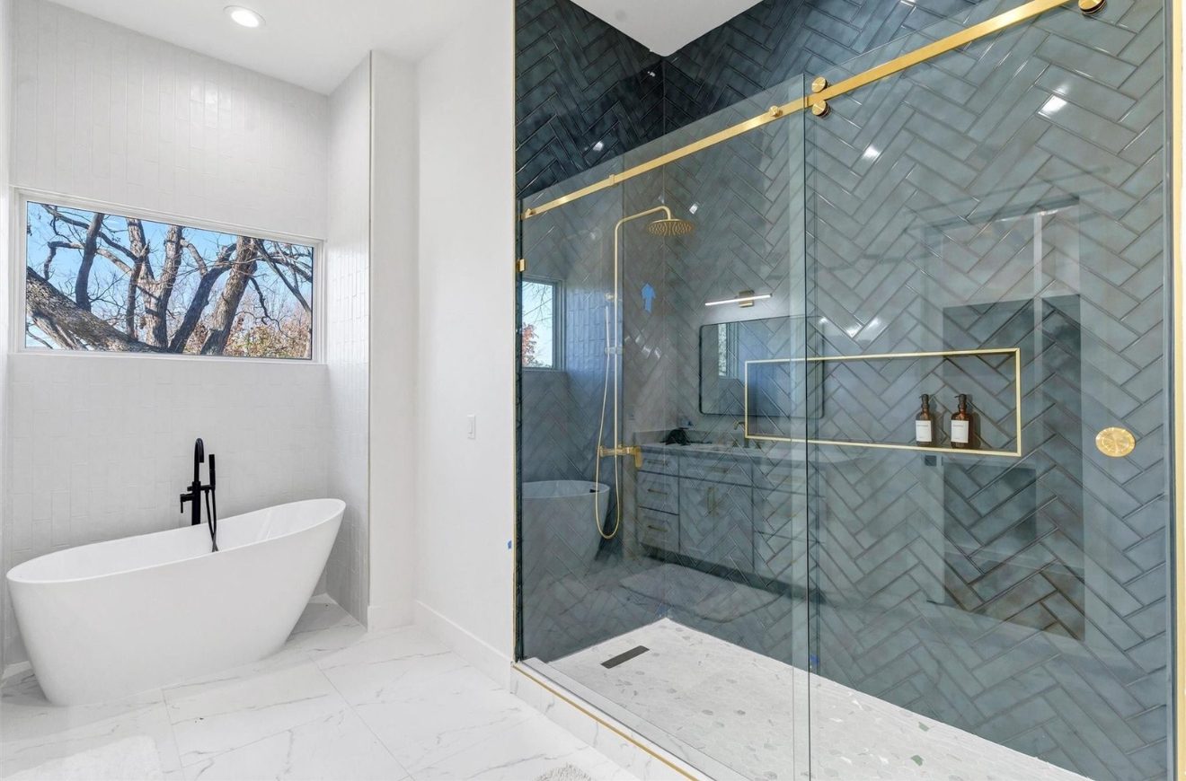 Bath with blue herringbone tile shower