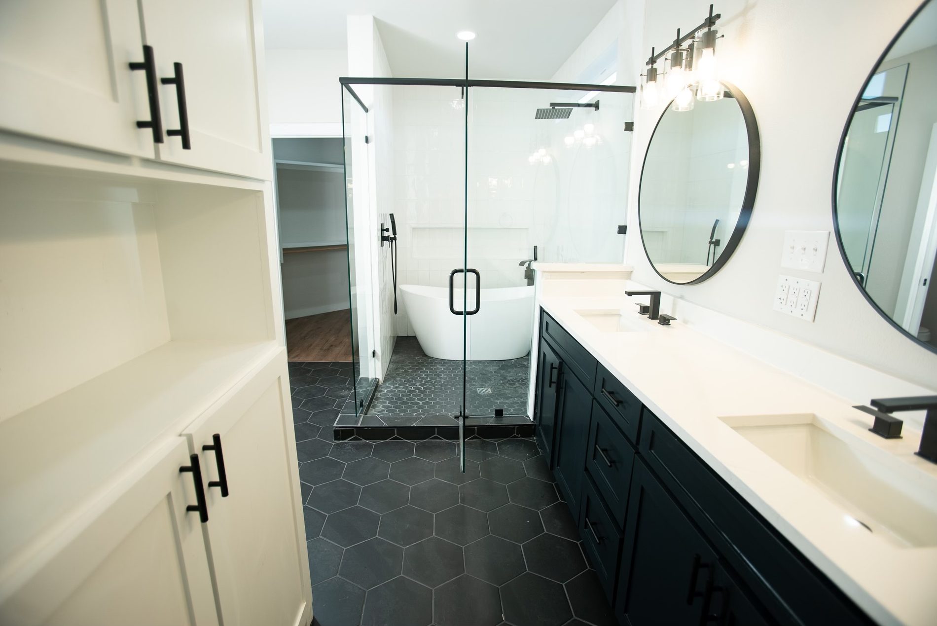 Primary bath with black hex floor and navy vanity