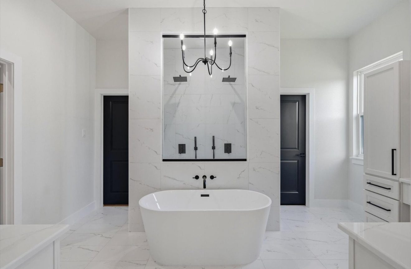 White marble bath with black fixtures