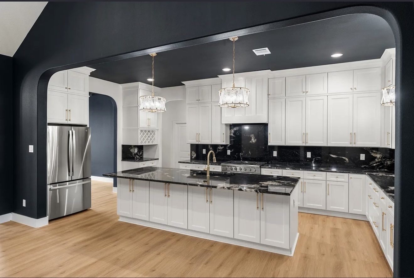 Wide view of white kitchen with black ceiling