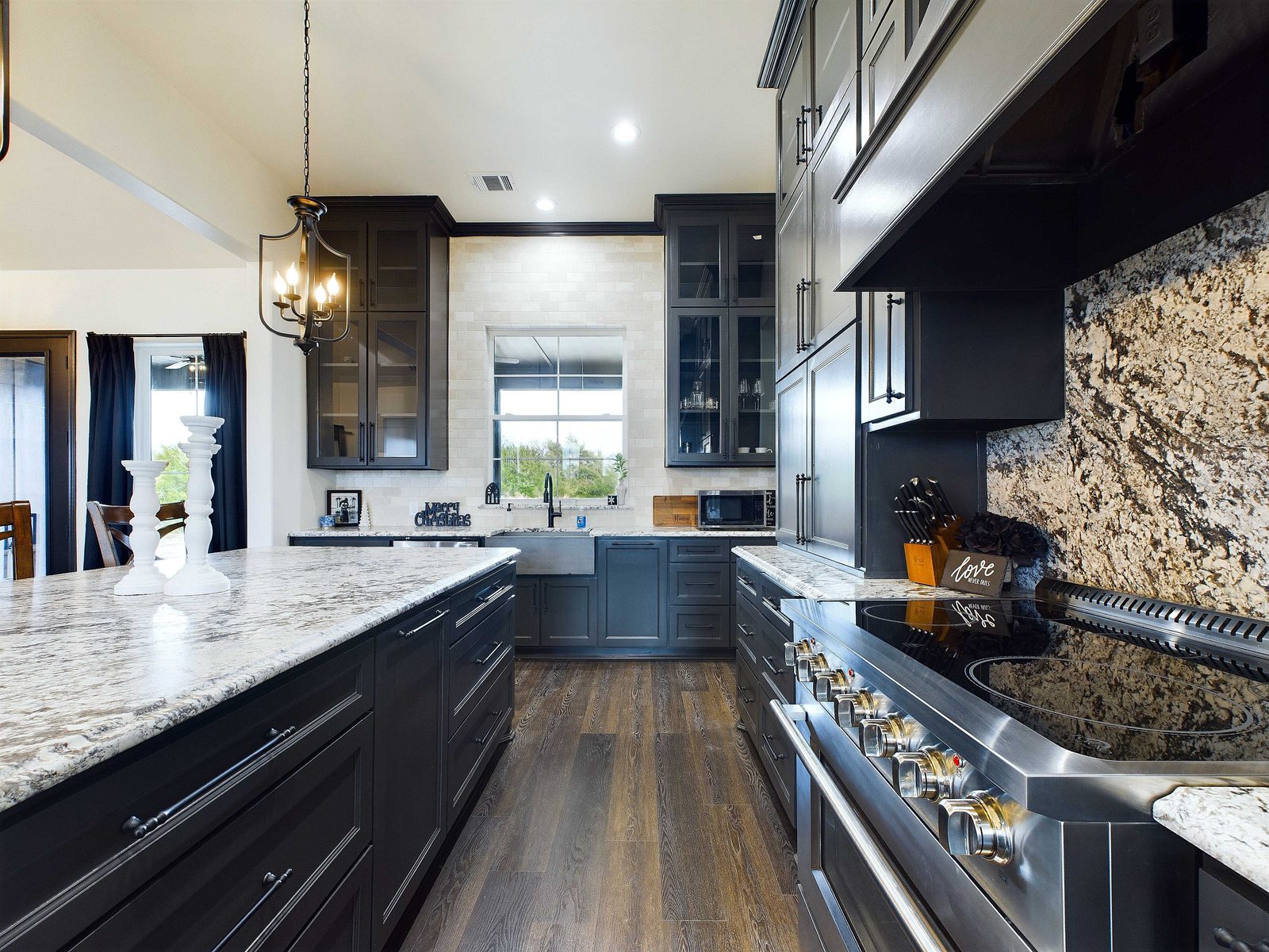 Custom kitchen with dark cabinetry and granite