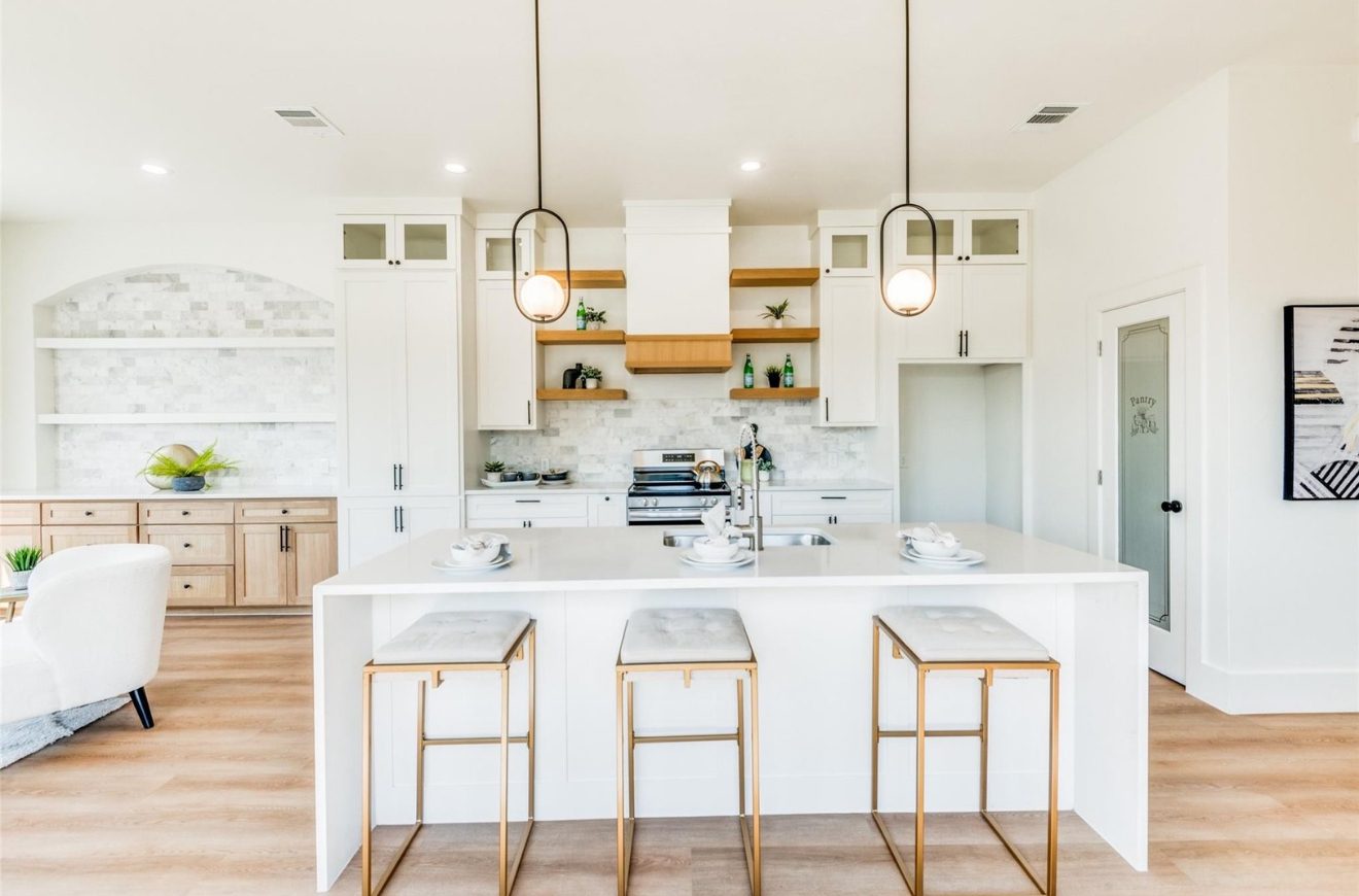 White kitchen with open wood shelving and marble backsplash