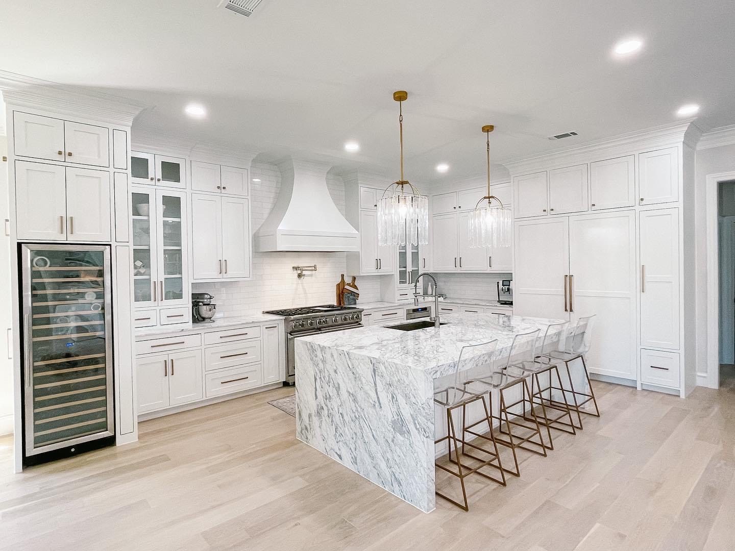 White kitchen with marble waterfall island