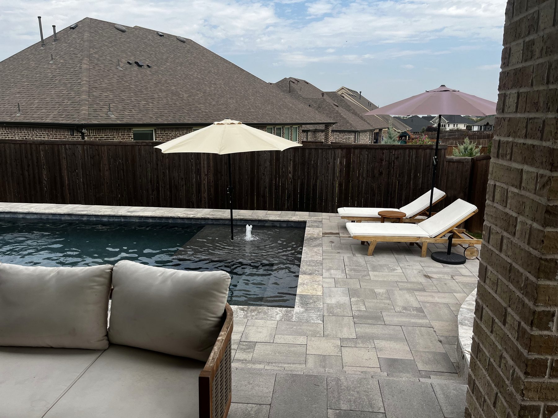 Pool with paver deck, loungers and pergola